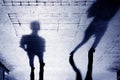 Shadow of two person on patterened sidewalk Royalty Free Stock Photo