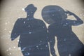 Shadow of two tourists on the beach Royalty Free Stock Photo