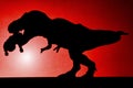 Shadow of tyrannosaurus biting a body on wall in red