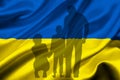 Shadow of a Ukrainian family fleeing the Ukrainian flag, Russia - Ukraine conflict Royalty Free Stock Photo