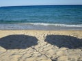 Shadow of umbrellas on the sand by the sea