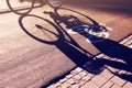 Shadow of unrecognizable cyclist on bicycle lane Royalty Free Stock Photo