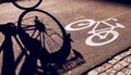 Shadow of unrecognizable cyclist on bicycle lane Royalty Free Stock Photo