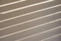 Shadow of venetian blinds on interior wall in sunlight, window blinds in house