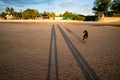 The shadow of a very long couple holding hand on a sand beach surface with black dog Royalty Free Stock Photo