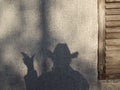 Shadow on a wall that looks like a cowboy