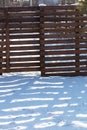 Shadow from a wooden fence on the snow in winter Royalty Free Stock Photo