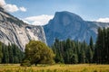 A shadowed half dome looms over the Yosemite valley floor Royalty Free Stock Photo