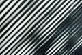 Shadows of black and white stripes on the wall. Natural abstract blurred background. Royalty Free Stock Photo
