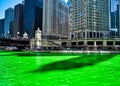 Shadows of buildings cast along the Chicago River which is dyed green for St. Patrick`s day