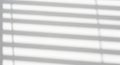 Shadows cast by blinds on a white wall creating a striped pattern Royalty Free Stock Photo