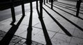 Shadows Cast by Metal Posts on Urban Sidewalk Creating Graphic Pattern Royalty Free Stock Photo