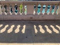 Shadows of concrete railing separating upper Chicago Loop with the Chicago River