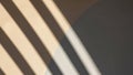 Shadows create parallel lines across a surface in warm beige Royalty Free Stock Photo