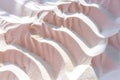 Shadows create patterns in warm sand with gentle curves. The light reveals soft textures and gradients from light to dark during Royalty Free Stock Photo
