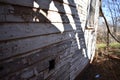 Shadows and flaking white paint on old house