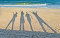 Shadows of four people against the background of the sea and sky Royalty Free Stock Photo