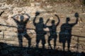 Shadows from four people on the wall Royalty Free Stock Photo