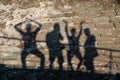 Shadows from four people on the wall Royalty Free Stock Photo