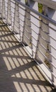 Shadows from Geometric Steel Railing on Bridge Royalty Free Stock Photo