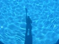 Shadows in the light blue swiming pool. Royalty Free Stock Photo