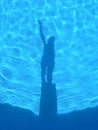 Shadows in the light blue swiming pool. Royalty Free Stock Photo