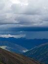 Shadows and Light: A Localized Rain Storm Sweeping Over Layered Mountain Ridges Royalty Free Stock Photo