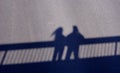 Shadows of a man and a woman on the bridge Royalty Free Stock Photo