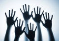 Shadows of many hands reaching up in a group Royalty Free Stock Photo