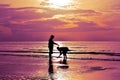 The shadows of men and women are walking on the beach at sunrise. Royalty Free Stock Photo