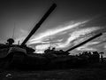 Shadows of military tanks at night at sunset