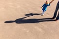 Shadows of mother and daughter holding hands on the road Royalty Free Stock Photo