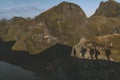 Shadows on the mountain of a group of mountaineers climbing the mountain at sunrise in Lofoten, Norway