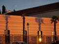 Shadows from palm trees on the facade of a building in the rays of the sun Royalty Free Stock Photo