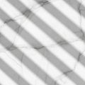 Shadows of parallel lines cast diagonally over a white marble surface with subtle gray veining. The Royalty Free Stock Photo