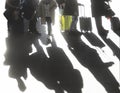 Shadows of people travelling with suitcases