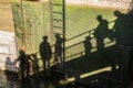 Shadows of people walking on bridge Royalty Free Stock Photo