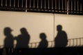 Shadows of people walking down a ramp in the summer Royalty Free Stock Photo