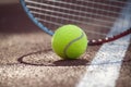 Tennis ball and racquet on outdoor court in sunshine Royalty Free Stock Photo