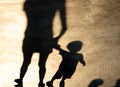 Shadows silhouettes of people on summer promenade Royalty Free Stock Photo