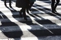 Shadows and silhouettes of people crossing the street Royalty Free Stock Photo