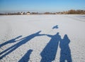 Shadows in the snow of a happy friendly family Royalty Free Stock Photo