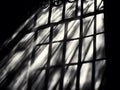Shadows of sunlight shining through a window grid structure Royalty Free Stock Photo