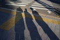 Shadows of three friends standing on the street in sunlight Royalty Free Stock Photo