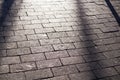 Shadows on the tile paved sidewalk with perspective. background, lighting.