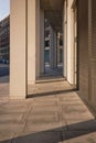 Shadowy city walkway next to modern building at night Royalty Free Stock Photo