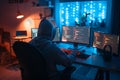 A shadowy figure of a hacker with a hoodie sits in a dark room, typing malicious code on a computer with multiple screens