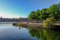 Shadwell Basin on a bright sunny early summer`s day with young p