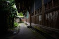 Shady alley before ancient Chinese timber houses Royalty Free Stock Photo