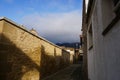 Shady alley with stone wall